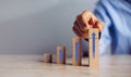 Businessman hand  arranging wood block stacking as step stair with arrow up.concept for business growth success process Royalty Free Stock Photo