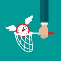 Businessman hand with butterfly net catches flying clock with wings.