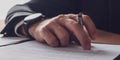 Businessman hand with elegant watch on his wrist holding and ink pen