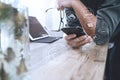 businessman hand with eyeglasses using smart phone,mobile payments online shopping,omni channel,digital tablet docking keyboard c Royalty Free Stock Photo