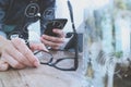 businessman hand with eyeglasses using smart phone,mobile payments online shopping,omni channel,digital tablet docking keyboard c Royalty Free Stock Photo