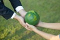 Businessman hand giving Earth globe to little boy as Earth day concept. Gyre