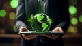 Businessman hand hold laptop with globe. ESG, Environment Social Governance. Reducing co2. Net Zero. Sustainable. ethical.