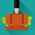 Businessman hand holding briefcase full of money