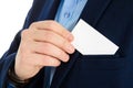 Businessman hand holding a business card over suit pocket, closeup. Isolated on white. Royalty Free Stock Photo