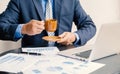 Businessman hand holding coffee cup, analysis the graph with laptop at the home office for setting challenging business goals And Royalty Free Stock Photo