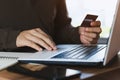 Businessman hand holding credit card with using laptop for online shopping while making orders at home. business Royalty Free Stock Photo