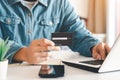 Businessman hand holding credit card with using laptop for online shopping while making orders at home. business. Royalty Free Stock Photo