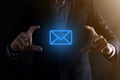 Businessman hand holding e-mail icon, Contact us by newsletter email and protect your personal information from spam mail. Royalty Free Stock Photo