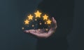 Businessman hand holding five stars. Royalty Free Stock Photo