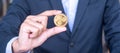 Businessman hand holding golden Ripple XRP cryptocurrency coin, Crypto is Digital Money within the blockchain network, is