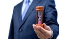 Businessman hand holding hourglass, Time management concept Royalty Free Stock Photo