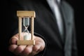 Businessman hand holding hourglass, Time management concept Royalty Free Stock Photo