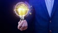 Businessman hand holding illuminated light bulb, New ideas with technological innovation and creativity. creative concept with Royalty Free Stock Photo