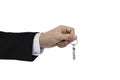 Businessman hand holding keys, isolated on white background Royalty Free Stock Photo