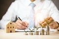 Businessman hand holding light bulb on coins stack on the wooden table , Saving ideas and investment budget, Creative ideas concep Royalty Free Stock Photo