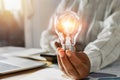 businessman hand holding light bulb in office. concept save energy power Royalty Free Stock Photo