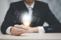 Businessman hand holding  light bulb and working on the desk, Creativity and innovation are keys to success.Concept of new idea an Royalty Free Stock Photo