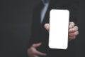 Businessman hand holding mobile white blank screen, Mock up cell mobile smart phone  in suit holds mobile phone with blank white s Royalty Free Stock Photo