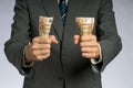 Businessman hand holding money, euro bills. Banknotes isolated gray background. Royalty Free Stock Photo