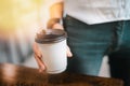 Hot drink in paper cup in hands close up