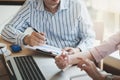 Businessman hand holding pen in meeting room Royalty Free Stock Photo