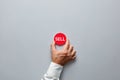 Businessman hand holding a red badge with the word sell. Decision to sell in finance or real estate Royalty Free Stock Photo