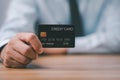 Businessman hand holding and showing mockup credit card on desk office