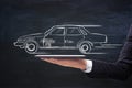 Businessman hand holding tablet with creative retro car sketch.