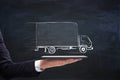 Businessman hand holding tablet with creative truck sketch. Transporation concept Royalty Free Stock Photo