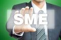 Businessman hand holding virtual screen with SME sign