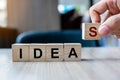 Businessman hand holding wooden cube block with IDEAS business word on table background. New Creative, Innovation, Imagination, Royalty Free Stock Photo