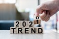 Businessman hand holding wooden cube with flip over block 2020 to 2021 TRENDS word on table background. Resolution, strategy, Royalty Free Stock Photo