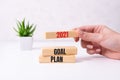Businessman hand holding wooden cube with text 2021 GOAL, PLAN and ACTION on table background. Resolution, strategy Royalty Free Stock Photo