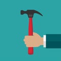 Businessman hand holds carpenter hammer Royalty Free Stock Photo