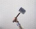 businessman hand holds hammer Thor Royalty Free Stock Photo