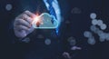 A businessman hand interacting with a glowing, virtual cloud icon, which features upload and download arrows Royalty Free Stock Photo