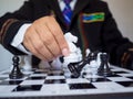 Businessman hand moving chess piece on board with white background, challenges planning business strategy to success concept Royalty Free Stock Photo