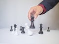 Businessman hand moving chess piece with white background, challenges planning business strategy to success concept Royalty Free Stock Photo