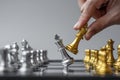 Businessman hand moving gold Chess King figure and Checkmate enermy or opponent during chessboard competition. Strategy, Success,