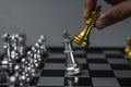 Businessman hand moving gold Chess King figure and Checkmate opponent during chessboard competition. Strategy, Success, management