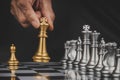 Businessman hand moving gold king with silver chess pieces on chess board game competition