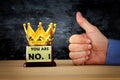 Businessman hand next to award trophy for show victory or winning first place Royalty Free Stock Photo