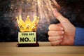 Businessman hand next to award trophy for show victory or winning first place Royalty Free Stock Photo