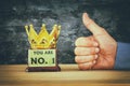 Businessman hand next to award trophy for show victory or winning first place Royalty Free Stock Photo