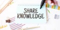 Businessman hand,paper plate,marker, diagram,chart and office tools. Text SHARE KNOWLEDGE Royalty Free Stock Photo