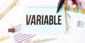 Businessman hand,paper plate,marker, diagram,chart and office tools. Text VARIABLE Royalty Free Stock Photo