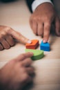 businessman hand placing the last jigsaw puzzle piece, Hand holding missing jigsaw puzzle piece down in to the place, conceptual Royalty Free Stock Photo