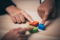 businessman hand placing the last jigsaw puzzle piece, Hand holding missing jigsaw puzzle piece down in to the place, conceptual Royalty Free Stock Photo