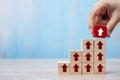 Businessman hand placing or pulling Red block with arrow and growth up arrow on table background. Business Growth, Improvement, Royalty Free Stock Photo